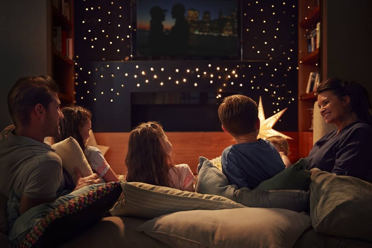 Family ENjoying Movie Night At Home Together